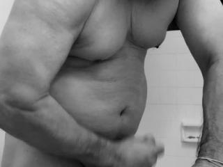 Old guy Flexing my small muscle in black and white color