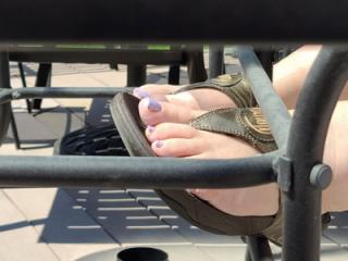 Sun tanning her feet and toes 4 of 5