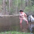 Bathing naked in the river.
