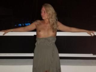 Horny GF strips and rubs her pussy on balcony 6 of 8