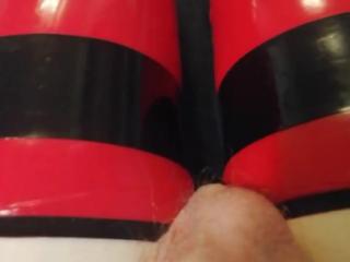 Shiny red latex rubber stockings closeup
