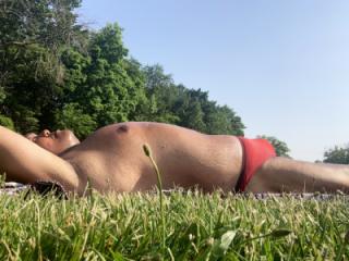 Sunbathing today in Bayonne Park in my red thong 5 of 6