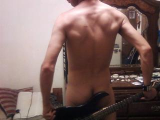 Posing naked with a guitar 4 of 5