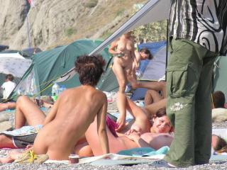 Enjoying sunny summer day at the beach with friends in nude by the ocean 3 of 4