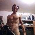 Posing naked with a guitar
