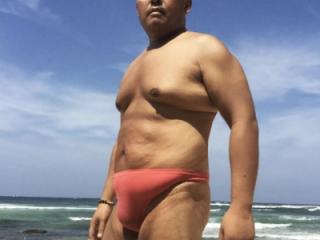 Orange thong and black speedo at the beach 1 of 9
