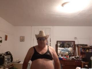 In sunglasses and bra and thong and cowboy hat 4 of 9