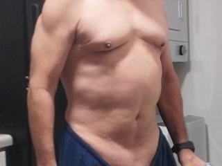 Old guy showing his small muscles