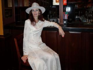 In Wedding Dress and White Hat on stage 12 of 20