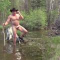 Sitting naked on a stump in the river.