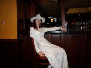 In Wedding Dress and White Hat on stage 7 of 20