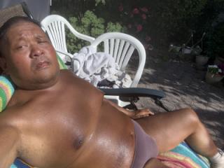 Sunbathing in my backyard in brown thong!!! I bet I STINK!