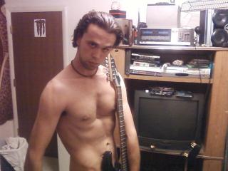 Posing naked with a guitar 2 of 5