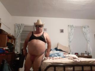 In sunglasses and bra and thong and cowboy hat