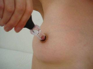 CLOSER finds pleasure in applying her new nipple rings with a pump