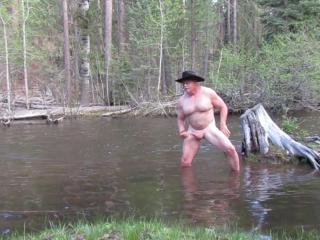 Bathing naked in the river.